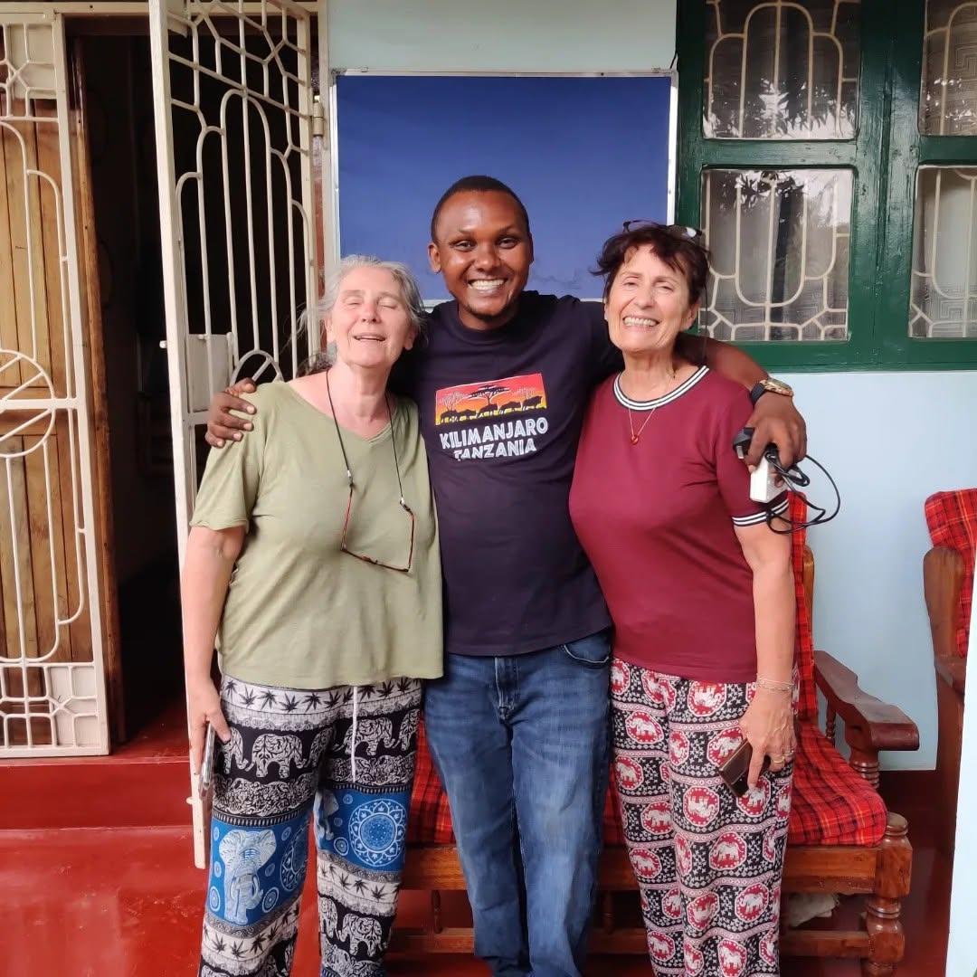 Cosmas with guests after a visit in Moshi