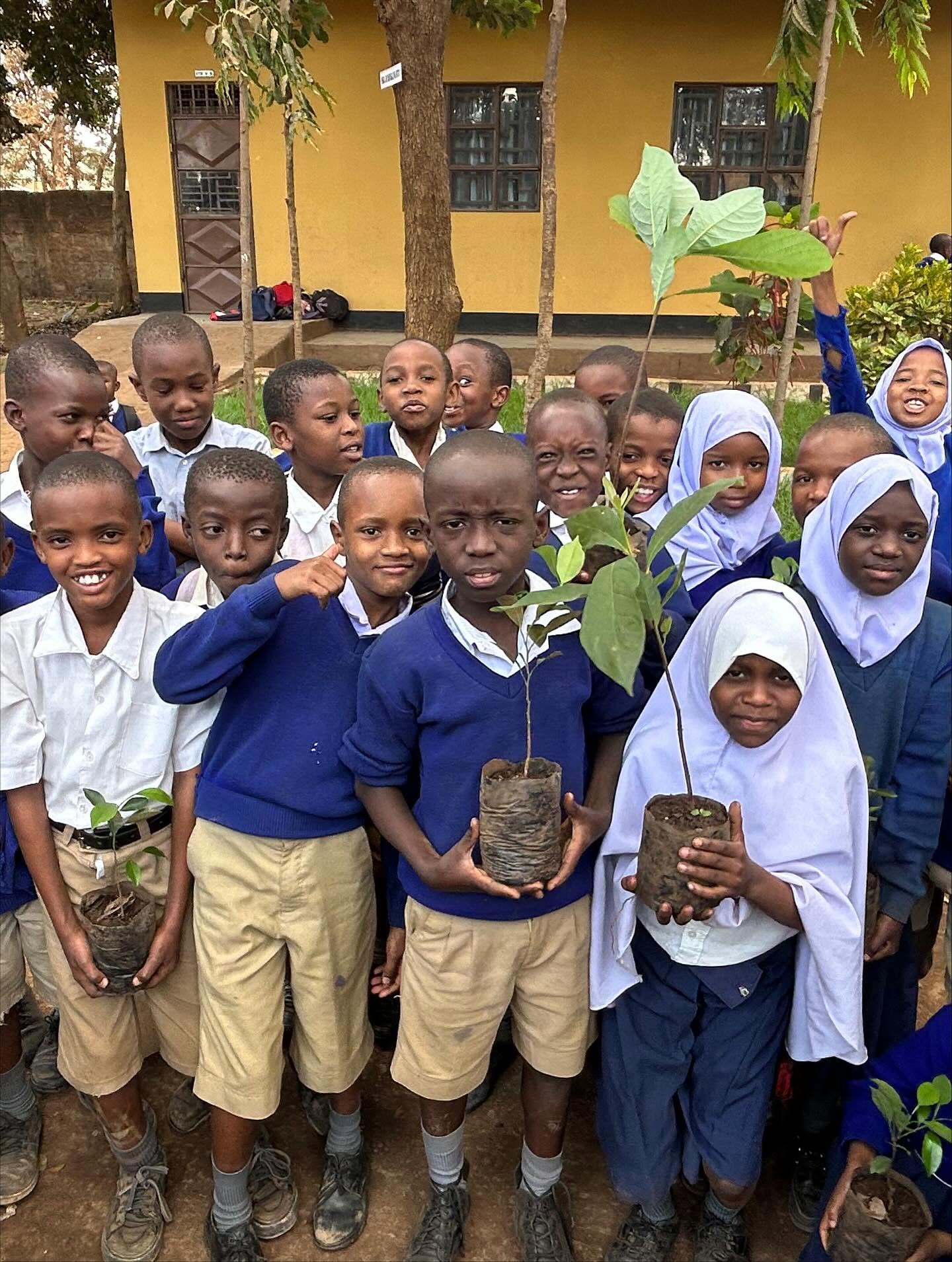 School children in Moshi holding tree saplings